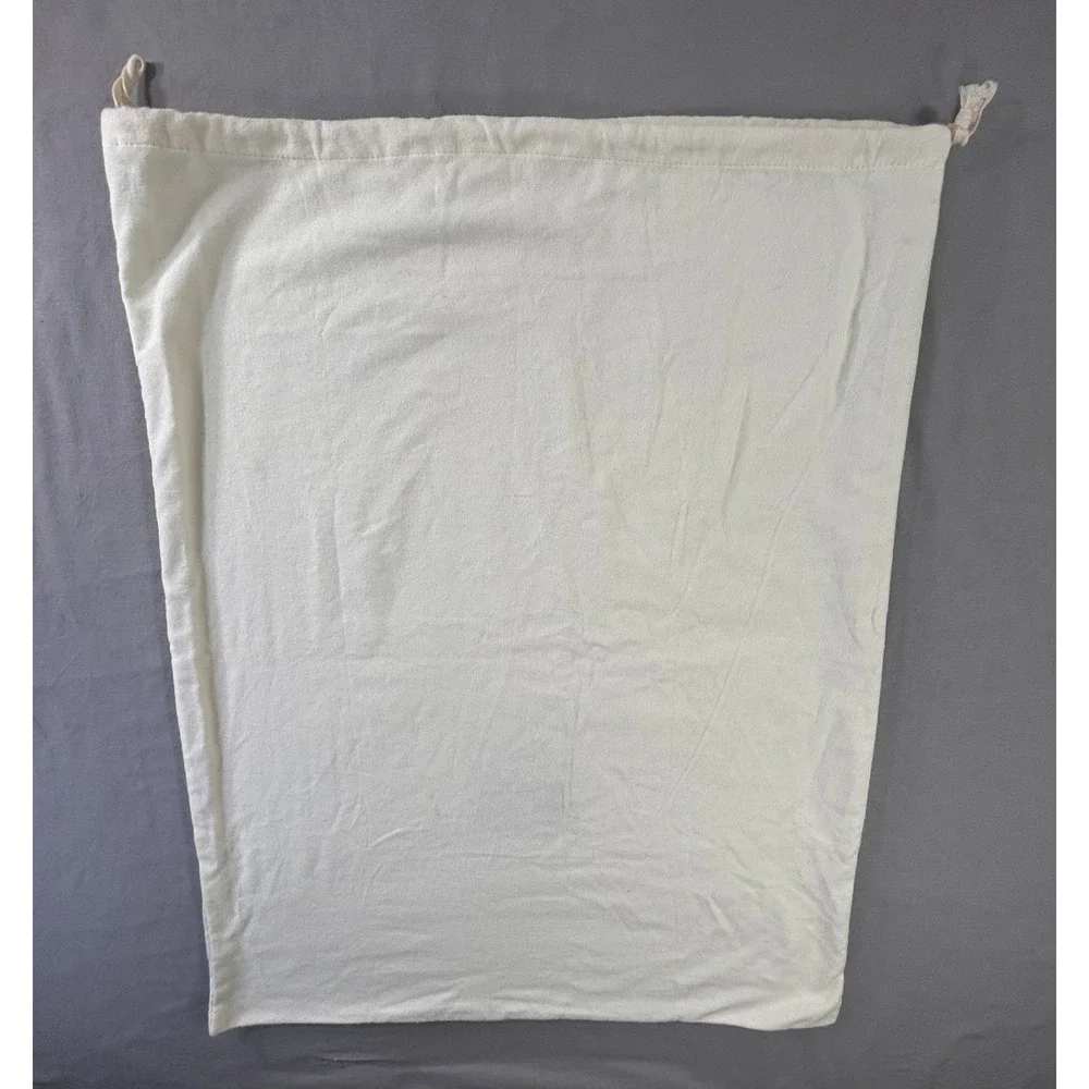 The Frye Company cream-colored cotton dust bag with‎ a drawstring closure boots